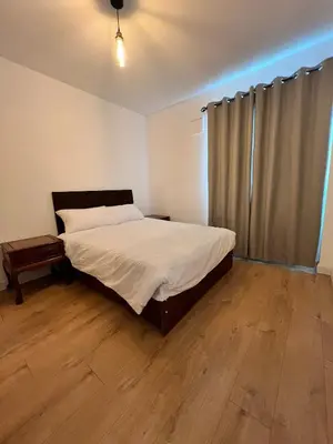 a bedroom with a bed and a wooden floor at Flat in London Bridge in Moffat