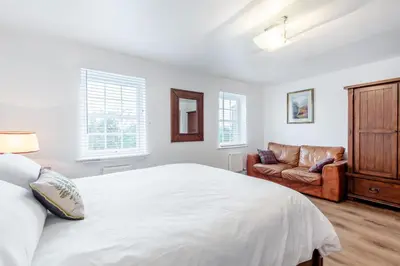 a white bedroom with a bed and a couch at 5 Bed in St. Bees oc-w32446 in St Bees