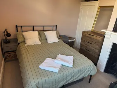 a bedroom with a bed with two towels on it at Southsea Home with Free Parking in Moffat