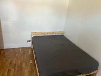 a bed in a corner of a room at Flat in Moffat