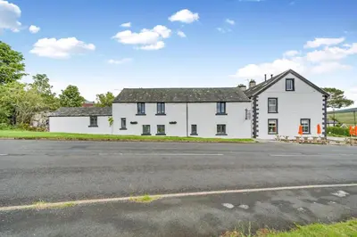 a white house with a road in front of it at 2 Bed in Troutbeck oc-b32579 in Troutbeck