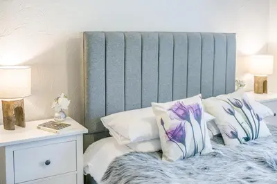 a bed with a blue headboard and white pillows at 2 Bed in Troutbeck oc-b32579 in Troutbeck