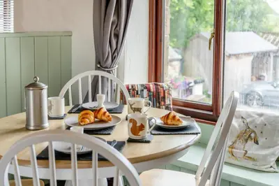 a table with plates of croissants and cups on it at 2 Bed in Troutbeck oc-s32564 in Troutbeck