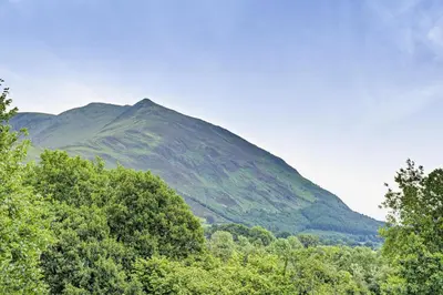 a mountain in the distance with trees in the foreground at 2 Bed in Ormathwaite oc-s32385 in Applethwaite