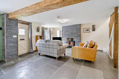 a living room with a couch and chairs and a fireplace at 2 Bed in Ormathwaite oc-s32385 in Applethwaite