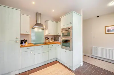 a kitchen with white cabinets and a stove at 2 Bed in Aspatria oc-p32645 in Aspatria