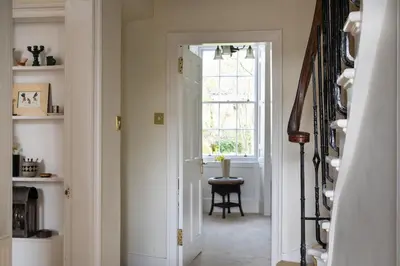 a hallway with a door leading to a room with a window at Elegant Town house in Edinburgh in Moffat