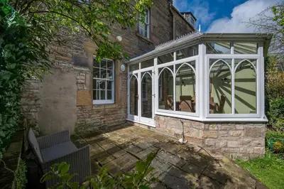 a conservatory in the side of a house at Elegant Town house in Edinburgh in Moffat