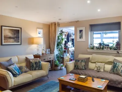 a living room with two couches and a table at Bay View in Maidens