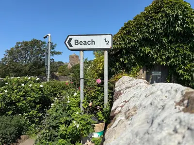 a street sign that reads beach next to a rock at Abbey Cottage in St Bees