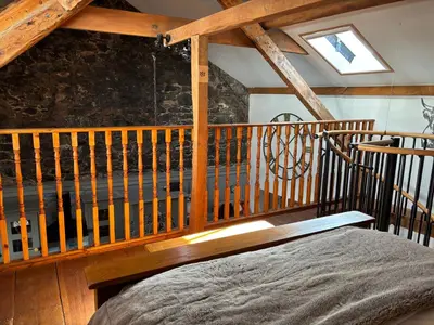 a bedroom with a bed and a wooden ceiling at Number 26 in Portpatrick