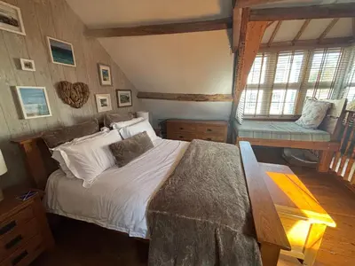 a bedroom with a bed and a bench in it at Number 26 in Portpatrick