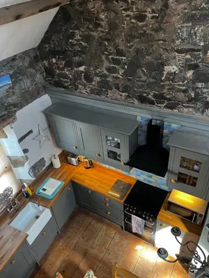 an overhead view of a kitchen with a stone wall at Number 26 in Portpatrick