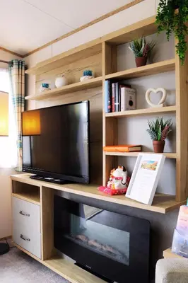 a entertainment center with a television in a living room at Relax, Enjoy fast Starlink Wi-Fi in Carlisle