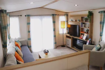 a living room with a couch and a tv at Relax, Enjoy fast Starlink Wi-Fi in Carlisle