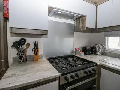 a kitchen with a stove top oven in a kitchen at Puffin in St Bees