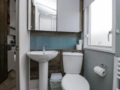 a small bathroom with a toilet and a sink at Puffin in St Bees