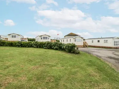 a yard with christmas trees in front of houses at Puffin in St Bees