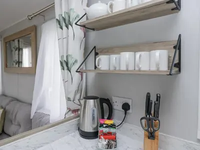 a kitchen counter with a coffee pot on a counter at Sandpiper in St Bees