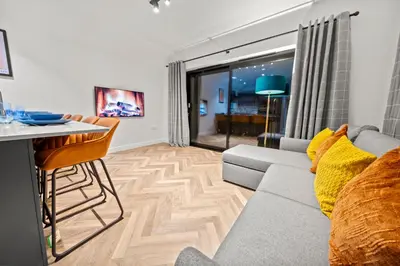 a living room with a couch and a table at The Salt Room Modern 1 Bedroom Home By AltoLuxo Short Lets Serviced Accommodation With Free Wifi & Parking in Moffat