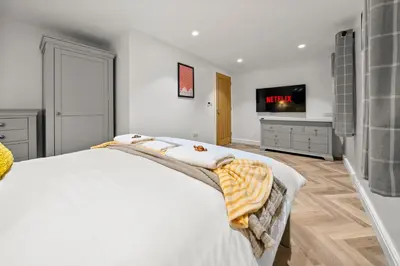 a bedroom with a bed and a flat screen tv at The Salt Room Modern 1 Bedroom Home By AltoLuxo Short Lets Serviced Accommodation With Free Wifi & Parking in Moffat