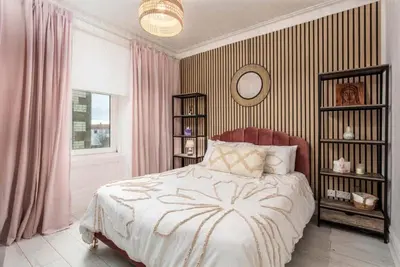 a bedroom with a large bed and a mirror at Sea view Villa Holiday and Corporate Let Accommodation in Prestwick