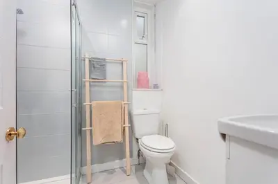 a white bathroom with a toilet and a shower at Sea view Villa Holiday and Corporate Let Accommodation in Prestwick