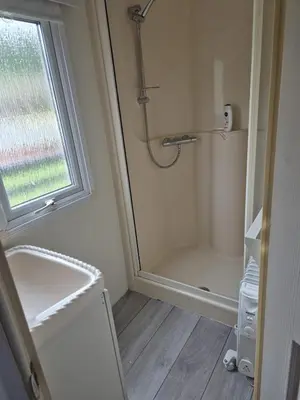 a small bathroom with a shower and a shower at Shep2 Caravans in Ballantrae