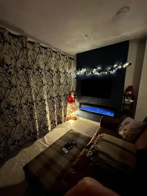 a living room with a couch and a television at Hamish's Hideaway in Eaglesfield