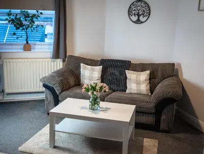 a living room with a couch and a coffee table at Bega House Apartment in Whitehaven