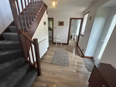 a hallway with stairs and a stair case at The Stables in Symington in Symington