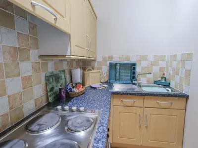 a kitchen with a stainless steel stove and a sink at The Hayloft in Wigton