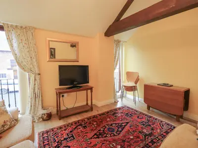 a living room with a flat screen tv and a couch at The Hayloft in Wigton