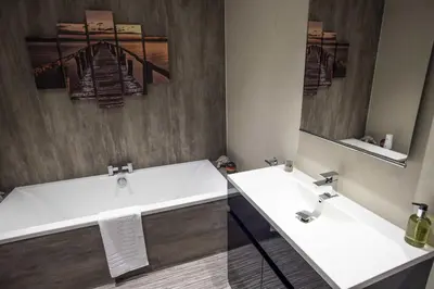 a bathroom with two sinks and a large mirror at Fellside Hideaway in Keswick