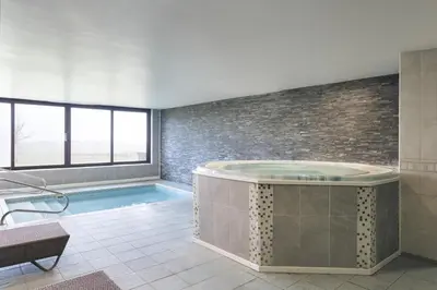 a large bathroom with a hot tub and a pool at The Hide - Ridgestone in Penrith