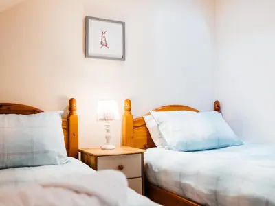 two beds sitting next to each other in a bedroom at The Barn in Girthon