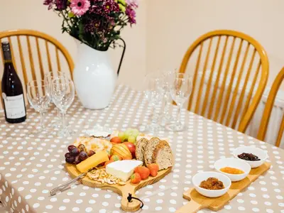 a plate of food on a table with wine glasses at The Barn in Girthon