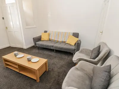 a living room with two couches and a coffee table at Cumberland House in Workington