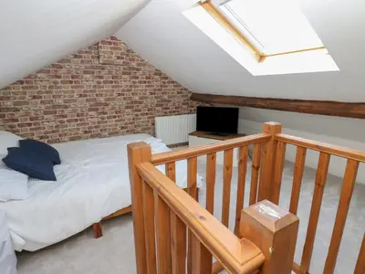a attic bedroom with a bed and a skylight at Lonsdale Street in Workington