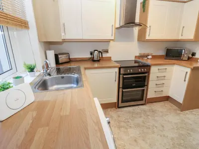 a kitchen with a sink and a stove top oven at Lonsdale Street in Workington