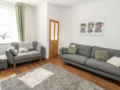 a living room with two couches and a rug at Lonsdale Street in Workington