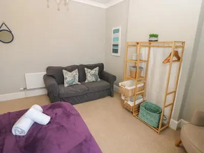 a living room with a couch and a chair at Hampton House in St Bees