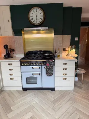 a kitchen with a stove and a clock on the wall at The Rookery in Moffat