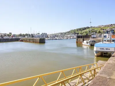 a view of a river with boats docked at Lowther House in Whitehaven