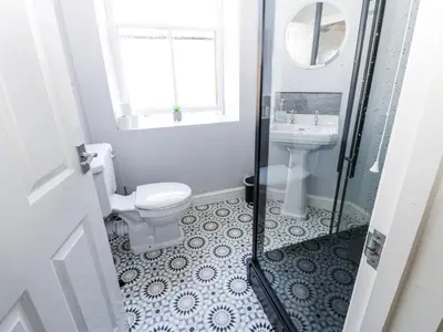 a bathroom with a toilet and a sink at Lowther House in Whitehaven