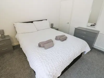 a bedroom with a bed with two towels on it at Bolton Terrace in Workington
