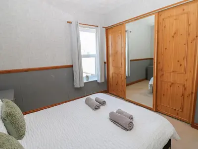 a bedroom with a bed with two towels on it at Bolton Terrace in Workington