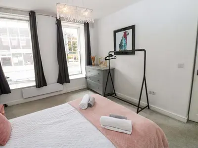 a bedroom with a bed with two towels on it at Lowther Suite in Whitehaven