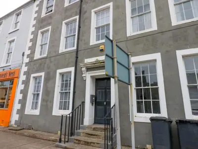a building with a door and stairs in front of it at Lowther Suite in Whitehaven