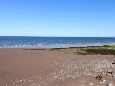 an empty beach with the ocean in the background at Georgian Town House in Whitehaven